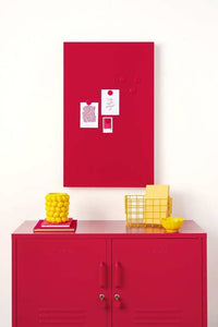 Red magnetic storyboard with notes hanging above matching red Mustard Made lockers