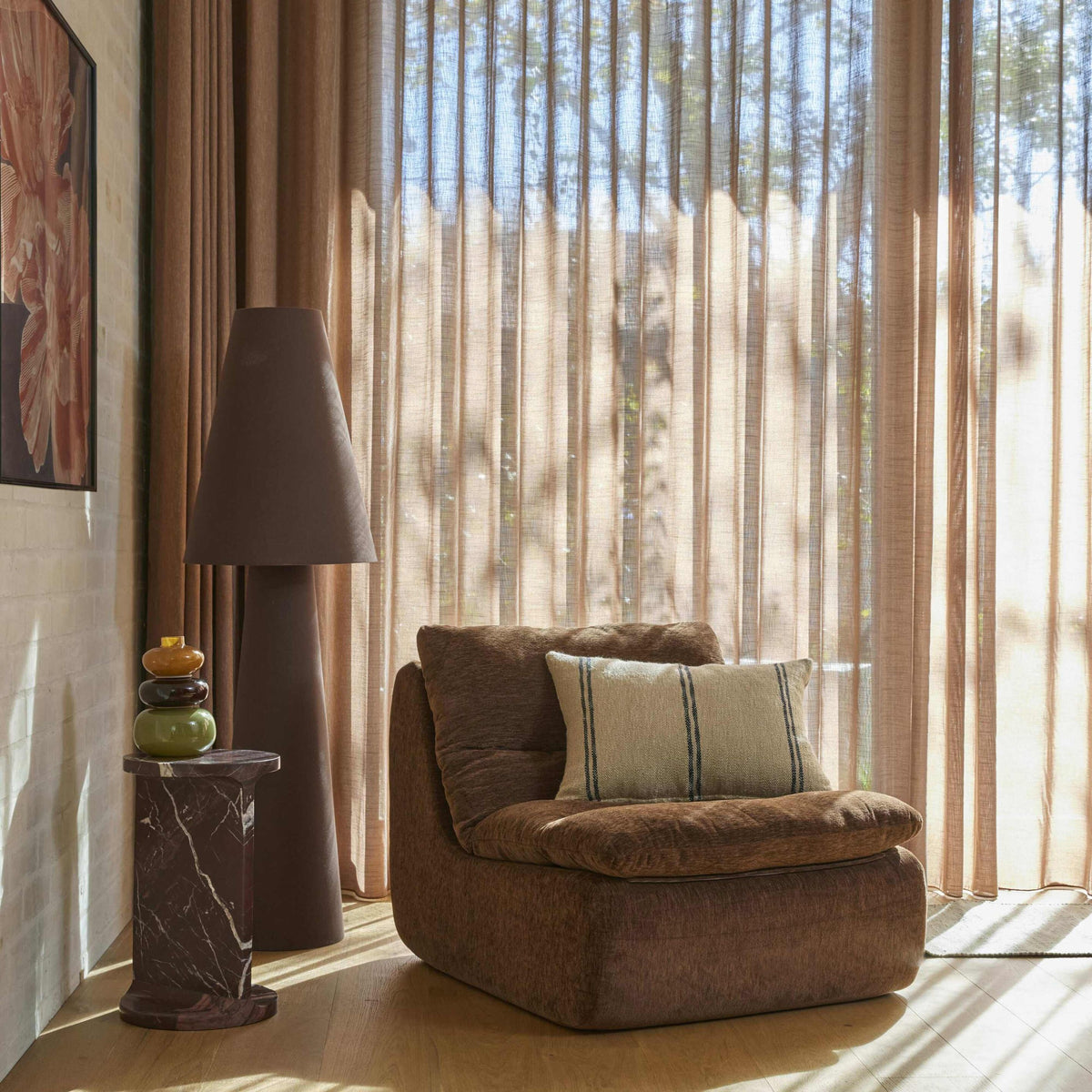 Linen Cone Floor Lamp beside an armchair in a sunlit living room