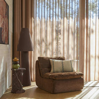 Linen Cone Floor Lamp beside an armchair in a sunlit living room