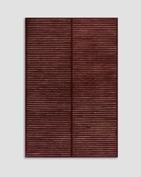 Baya Marlow floor rug in Wine, full rug shown flat on a grey background