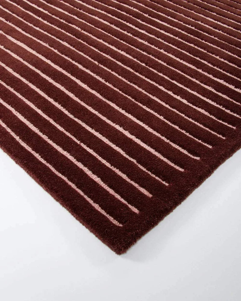 Baya Marlow Floor Rug in wine color with hand-tufted 100% New Zealand wool and linear pattern