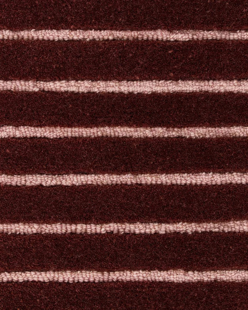 Baya Marlow Floor Rug in wine with burgundy and pale pink horizontal stripes, 100% NZ wool, hand-tufted loop pile, 15mm depth.