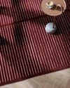 Baya Marlow Floor Rug in wine color with burgundy and pale pink stripes, hand-tufted 100% New Zealand wool texture.