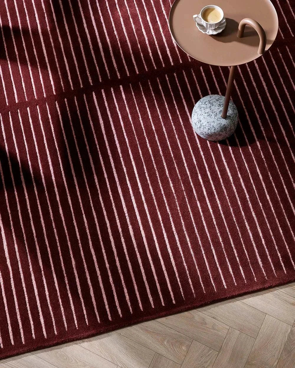 Baya Marlow Floor Rug in wine color with burgundy and pale pink stripes, hand-tufted 100% New Zealand wool texture.
