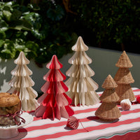 norsu Merry Merry Paper Trees grouped in Latte/Cream and Red/Pink on a striped tablecloth