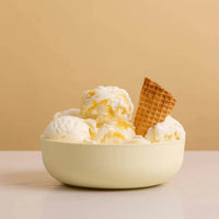 Styleware sorbet yellow nesting bowl filled with vanilla ice cream and waffle piece