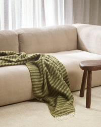 Baya Noah Throw in Olive styled on a sofa