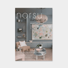 Cover of norsuHOME 2 digital magazine Chapter Eight featuring a formal sitting room with a pastel armchair, coffee table, built-in shelving, and abstract wall art