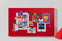 Red magnetic storyboard with colorful magnets displaying photos and notes, designed to match Mustard Made lockers