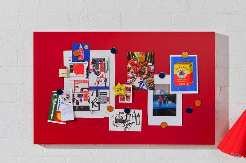 Red magnetic storyboard with colorful magnets displaying photos and notes, designed to match Mustard Made lockers
