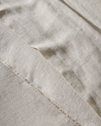 Hem detail on the Weave Home Sova flat sheet in Savanna linen