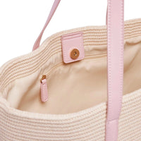 Interior close-up of Base Supply Panier bag in pink with woven straw, cotton lining, zipped pocket, and magnetic closure