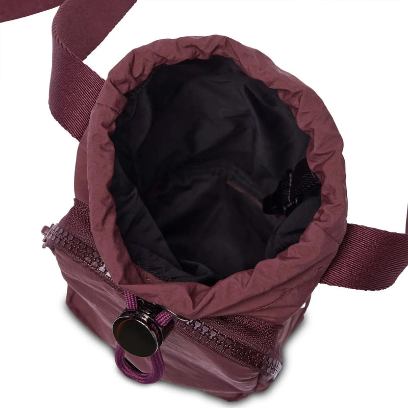 Base Supply Bottle Sling crossbody bag in burgundy with waterproof fabric and adjustable strap