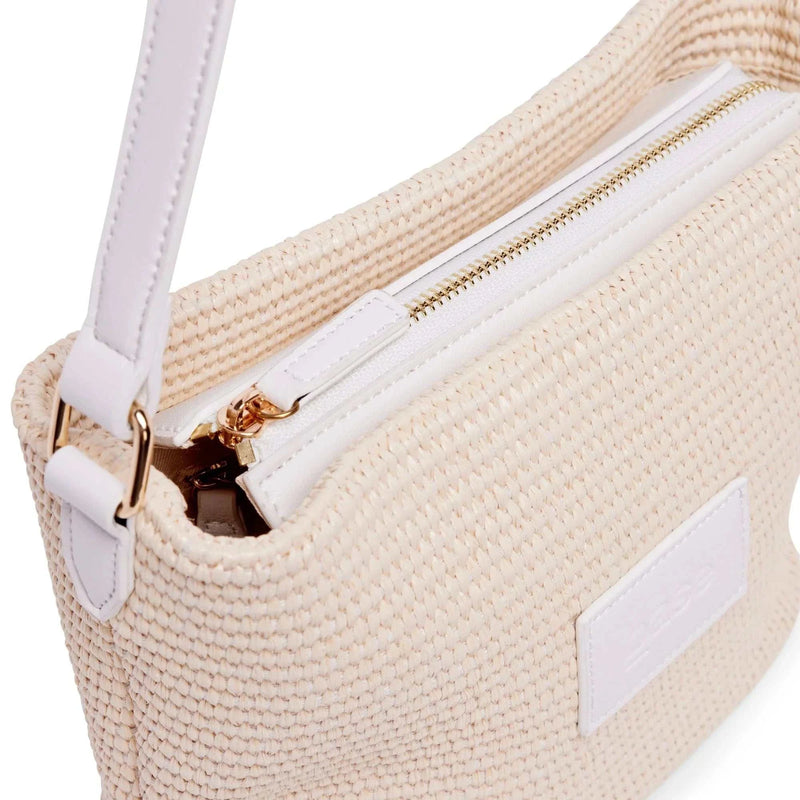 Base Supply Panier crossbody bag in chalk with woven straw texture, adjustable strap, zip-top, and cotton lining