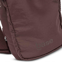 Base Supply Bottle Sling crossbody bag in chocolate color, lightweight waterproof fabric with adjustable strap and front zip pocket