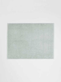 Paros Bath Mat in limestone color made from sustainable cotton with reversible design and high absorbency.