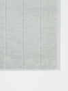 Paros Bath Mat in limestone color made from sustainable cotton with a soft, absorbent texture and simple striped design.