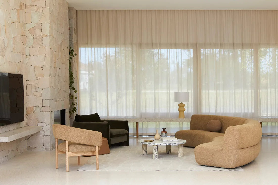 Globe West Amara oval coffee table with natural ocean marble top and round marble pillar legs