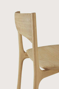 Ethnicraft PI Dining Chair in natural oak with sleek, curved wooden design and polished imperfect finish.