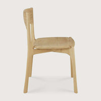 Side view of Ethnicraft PI Dining Chair in natural oak with curved backrest and cushioned seat