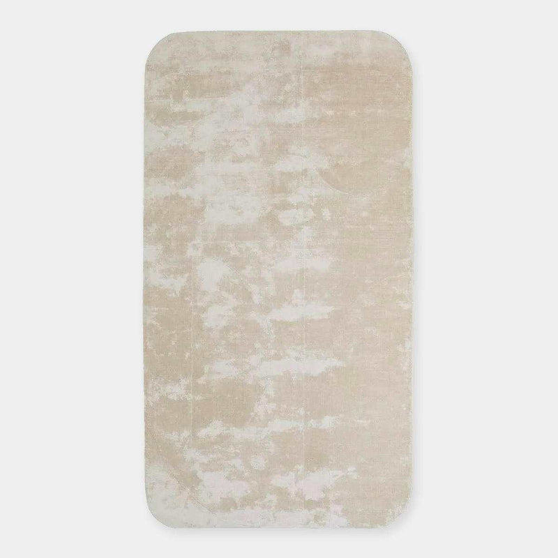 GlobeWest Tepih Curve Rug in sand color with soft hand-woven texture and subtle pattern for indoor use