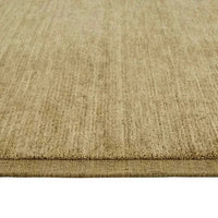 Close-up of GlobeWest Bower Frame Rug in moss color, hand woven wool, indoor area rug with simple textured design