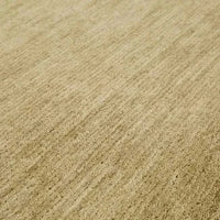 Close-up of GlobeWest Bower Frame Rug in moss color, hand-woven 100% wool texture