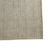 Silver grey hand-woven GlobeWest Tepih Neptune rug with wool, silk, and cotton blend, shown close-up on white background