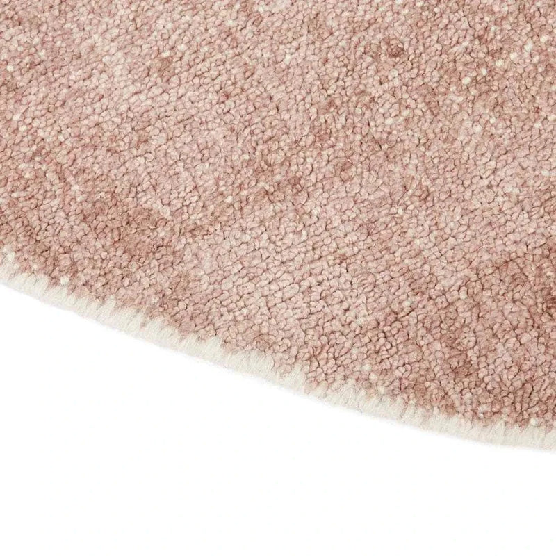 Close-up of GlobeWest Tepih Neptune round hand-woven indoor rug in dusty rose with wool, silk, and cotton blend texture