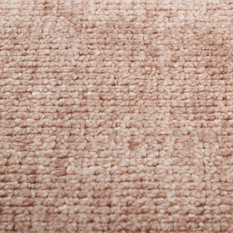 Close-up of GlobeWest Tepih Neptune round rug in dusty rose color with hand-woven wool, silk, and cotton texture