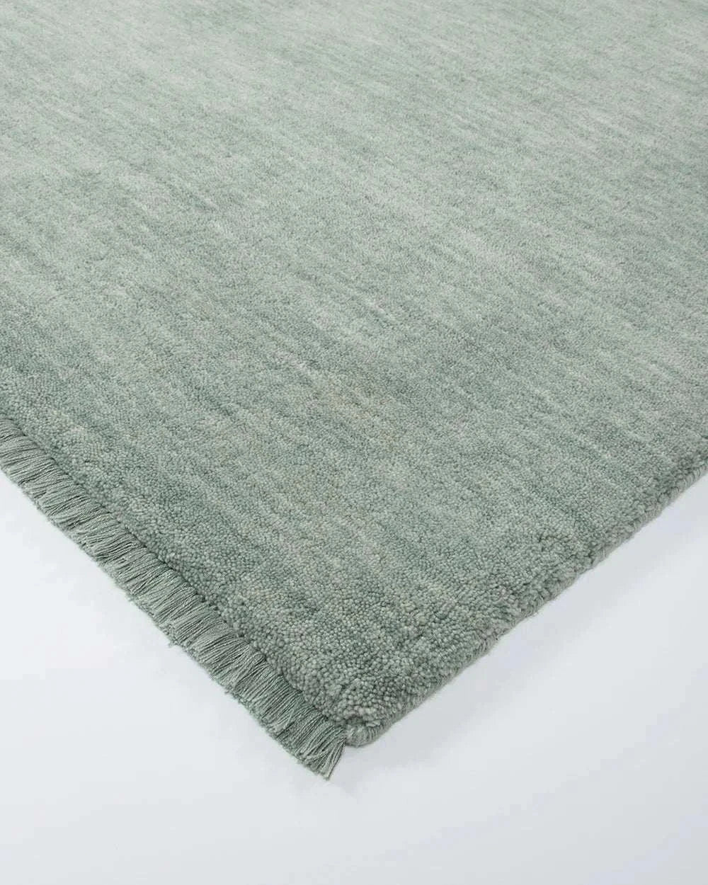 Baya Sandringham Floor Rug in aquamarine with hand-knotted loop pile and delicate fringing