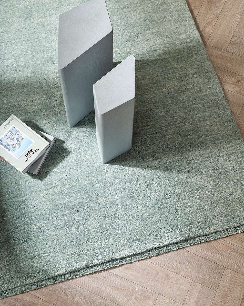 Baya Sandringham Floor Rug in aquamarine with soft dense pile and delicate fringed edges on wooden floor