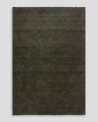 Forest green Sandringham Floor Rug with dense wool pile and delicate fringed edges.