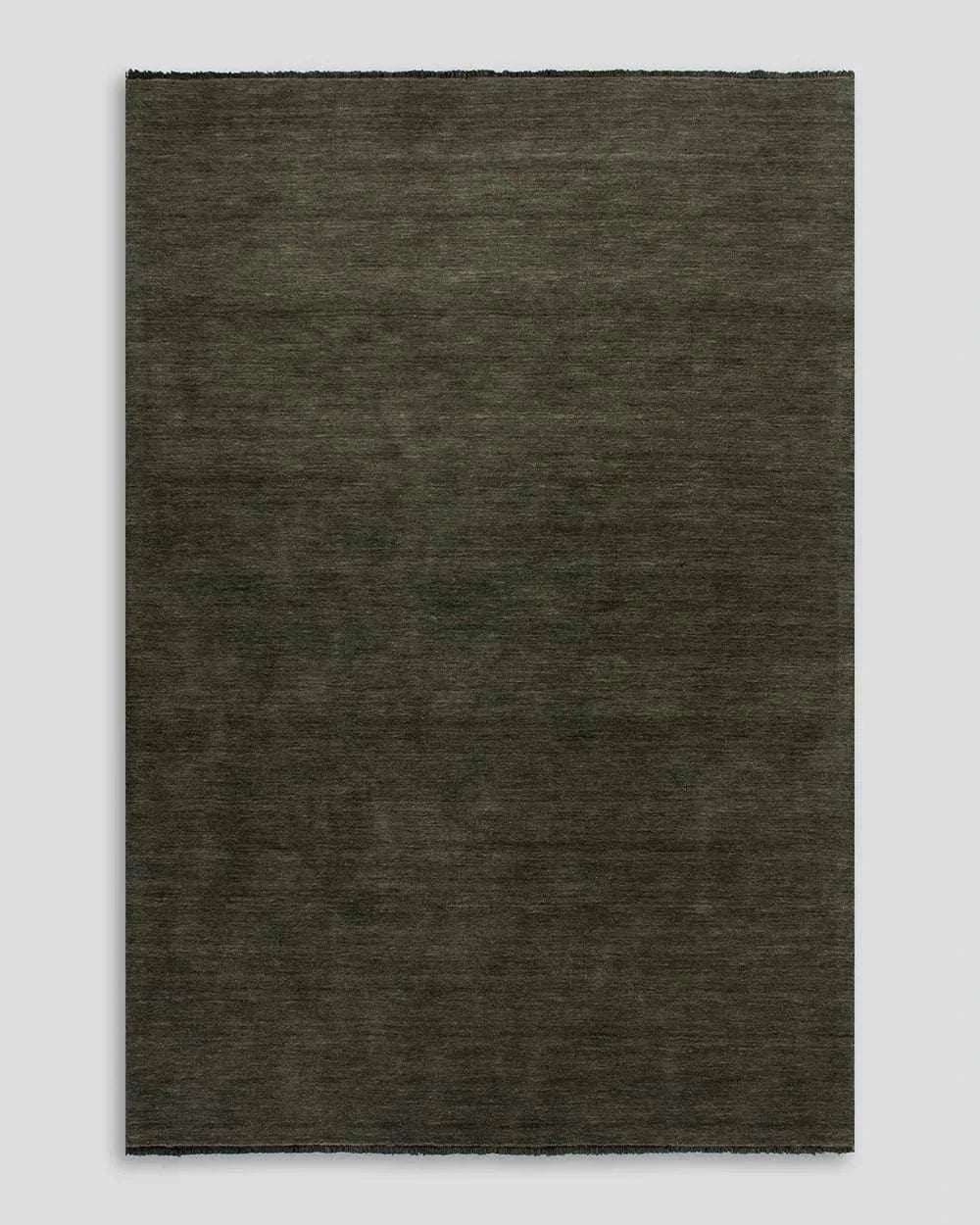 Forest green Sandringham Floor Rug with dense wool pile and delicate fringed edges.