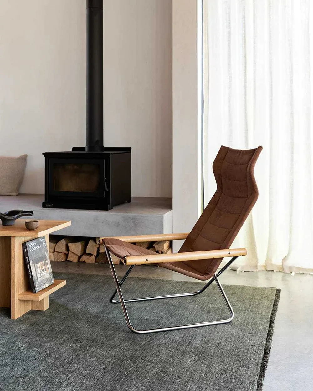 Forest green Sandringham Floor Rug in a modern living room with a wood-burning stove and minimalist chair