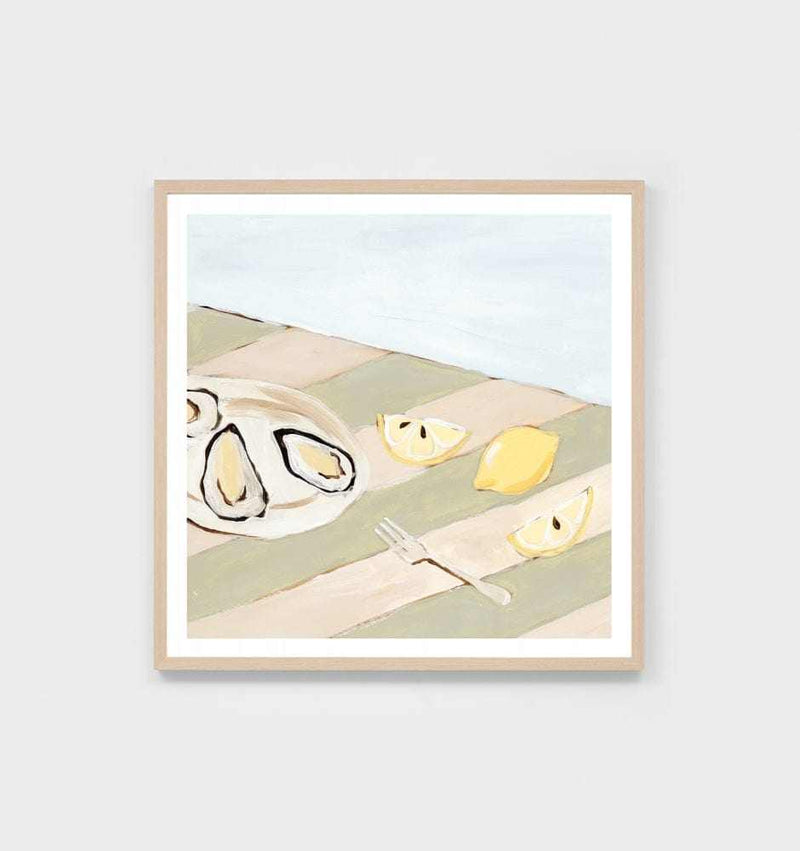 Middle of Nowhere seaside dining still life print with oysters, lemon wedges, and fork on a striped sage tablecloth in a light wood frame