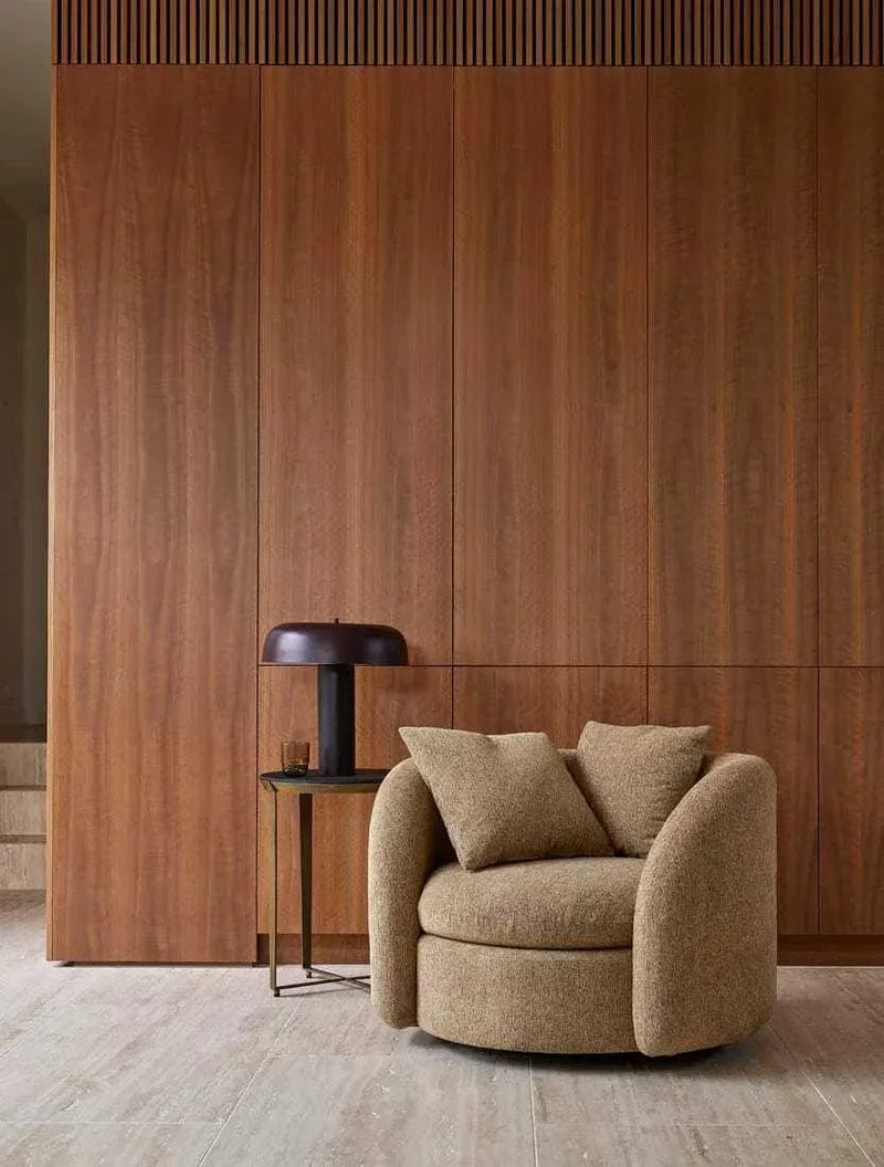 Globe West Canopy Table Lamp in burgundy with modern metal design on side table next to beige armchair in minimalist living room