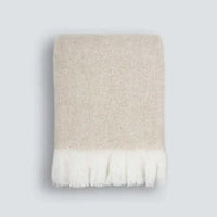 Baya Sorrento Throw in off-white with soft brushed wool blend and feathered fringe detail