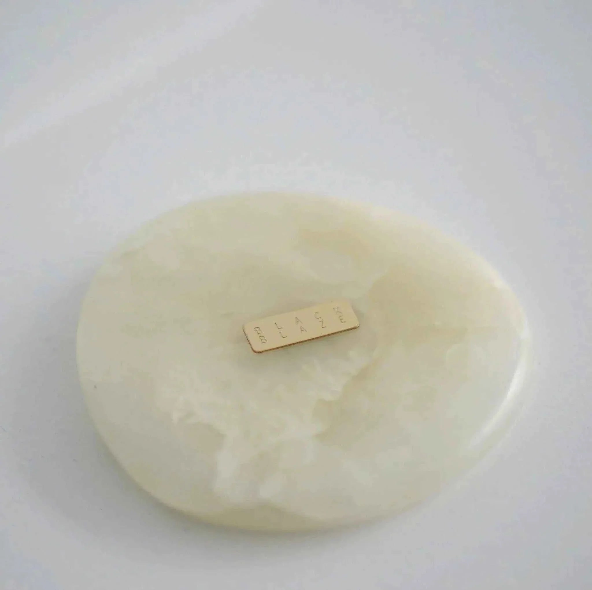 Black Blaze White Onyx Marble Coaster with irregular circular design and natural stone pattern