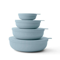 Set of four sky blue Styleware nesting bowls with snap-tight lids, BPA-free and dishwasher safe.