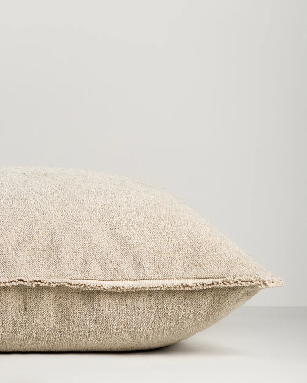 Baya Sutton Cushion in oat color with cotton-linen chenille and fringe border