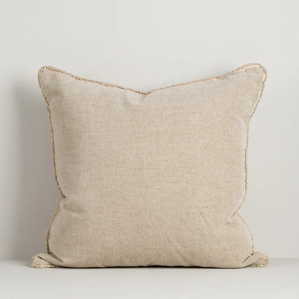 Baya Sutton Cushion in oat color with cotton-linen chenille fabric, velvety pile, woven border, and fringe detailing