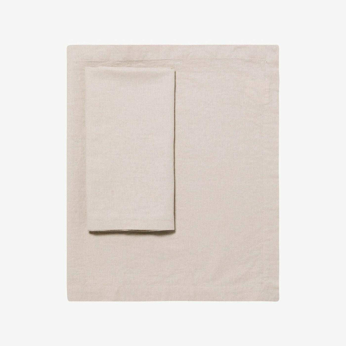 L&M Terrace Oatmeal Tablecloth made from 55% French linen and 45% cotton blend in a soft oatmeal color, available in various sizes.
