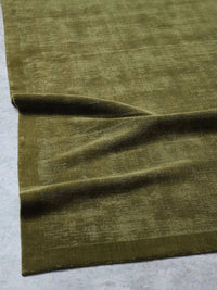 Tribe Home Tait Rug in olive color hand-loomed from New Zealand wool with tip-sheared texture