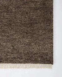 Close-up of brown Baya Tanami floor rug hand-knotted from 100% New Zealand wool with soft cotton fringe