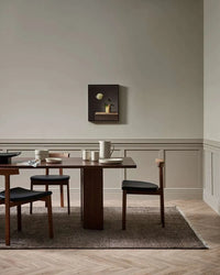 Baya Tanami Floor Rug in earthy brown with hand-knotted ribbed texture and soft cotton fringe in a modern dining room setting