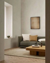 Baya Tanami Floor Rug in fossil taupe tone, hand-knotted New Zealand wool with cotton fringe in minimalist living room setting