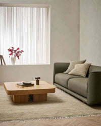 Baya Tanami Floor Rug in fossil taupe with hand-knotted wool texture and soft cotton fringe in a modern living room setting