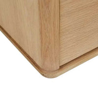 Close-up of GlobeWest Henry Entertainment Unit corner in light oak with chamfered plinth base and oak veneer finish