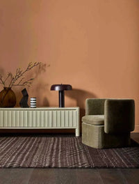 Modern Globe West Canopy Table Lamp in burgundy metal on cream sideboard with decorative items in stylish living room setting